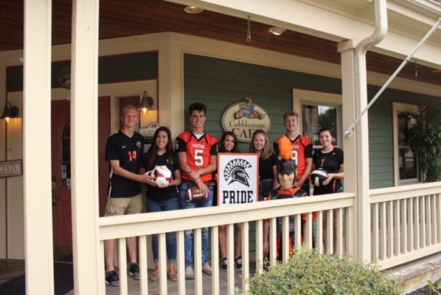 people wearing jerseys and holding sign